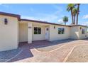 Beige home with front entrance and paver walkway surrounded by desert landscaping at 701 W Windsor Ave, Phoenix, AZ 85007