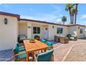 Inviting outdoor dining space with a wooden table, grill, and cozy seating area at 701 W Windsor Ave, Phoenix, AZ 85007