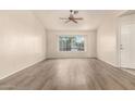 Sunny living room features new flooring and a large window for lots of light at 860 N Mcqueen Rd # 1157, Chandler, AZ 85225