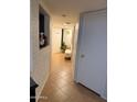 Inviting hallway featuring tile flooring and neutral décor, perfect for a welcoming transition at 9060 N 47Th Ln, Glendale, AZ 85302