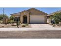 Inviting single-story house with a two-car garage, desert landscaping, and a welcoming entryway at 10837 W Bloch Rd, Tolleson, AZ 85353