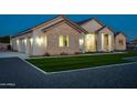 Charming exterior showcasing manicured landscaping, stone accents, and ample parking with a three car garage at 1229 N 106Th Pl, Mesa, AZ 85207