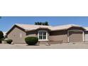 This home features a two-car garage, a neutral exterior color scheme, and desert landscaping at 1320 E Bellerive Dr, Chandler, AZ 85249