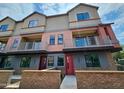 Townhouse exterior featuring a red door, brick accents, balconies, and modern architectural design at 1401 S Rita Ln, Tempe, AZ 85281