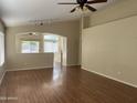 Open-concept living room featuring vaulted ceilings and durable laminate flooring at 14228 N 150Th Ln, Surprise, AZ 85379