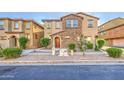 Charming two-story home with a stone facade, well-maintained landscaping, and a cozy entrance at 1624 N 77Th Gln, Phoenix, AZ 85035