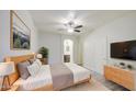 Comfortable main bedroom with a wooden bed frame, a ceiling fan, and an ensuite bathroom at 1624 N 77Th Gln, Phoenix, AZ 85035