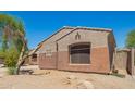 Side view of single-story home with desert landscaping and neutral-toned stucco exterior at 18322 W Sweet Acacia Dr, Goodyear, AZ 85338