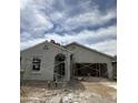 A house under construction is shown with scaffolding in front of the garage and entryway at 1973 E Bucking Bronco Dr, San Tan Valley, AZ 85140