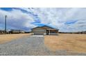 Charming single-story home featuring a two-car garage and gravel landscaping at 20411 W Mountain Sage W Dr, Buckeye, AZ 85326