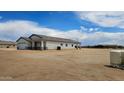 Charming single-story home with stucco exterior, and an attached garage, all under a clear blue sky at 20419 W Mountain Sage Dr, Buckeye, AZ 85326