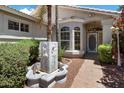 Inviting front entrance with a decorative fountain, manicured bushes, and a stylish front door for added curb appeal at 21675 N 61St Ave, Glendale, AZ 85308