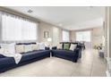 Spacious living room featuring neutral decor, tile flooring, and an abundance of natural light at 2543 N 73Rd Dr, Phoenix, AZ 85035