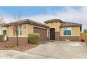 Single-story home with a neutral stucco exterior, tile roof, and well-maintained front yard at 25955 W Deer Valley Rd, Buckeye, AZ 85396