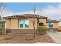 Inviting single-story home with a neutral stucco exterior, tile roof, and low-maintenance landscaping at 25955 W Deer Valley Rd, Buckeye, AZ 85396