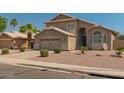 Inviting two-story home featuring a two-car garage and low-maintenance desert landscaping at 321 W Betsy Ln, Gilbert, AZ 85233