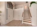 Bright foyer with tile flooring, staircase, and high ceilings at 321 W Betsy Ln, Gilbert, AZ 85233