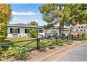Attractive single-story home featuring a well-kept lawn, charming fence and shade tree at 3308 N 51St St, Phoenix, AZ 85018