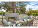 Stylish outdoor patio area with a modern fireplace, comfortable seating, and inviting ambiance at 3308 N 51St St, Phoenix, AZ 85018