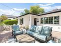 Inviting outdoor patio featuring comfortable seating, string lights, and well-manicured landscaping at 3308 N 51St St, Phoenix, AZ 85018