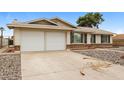 Exterior view of a home with a double garage and well-maintained front yard at 3337 W Yucca St, Phoenix, AZ 85029