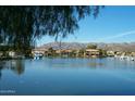 Beautiful lake view of waterfront homes with mountains in the background, reflecting in the water at 3631 E Long Lake Rd, Phoenix, AZ 85048