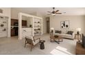 Open concept living room features a built-in shelving unit and views of the kitchen at 3631 E Long Lake Rd, Phoenix, AZ 85048