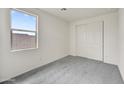 Carpeted bedroom featuring neutral paint, a window, and sliding closet doors at 37549 W San Clemente St, Maricopa, AZ 85138