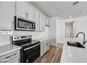Close-up showcasing modern stainless steel appliances and white cabinets in a well-lit kitchen at 37549 W San Clemente St, Maricopa, AZ 85138