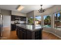 Well-appointed kitchen with granite countertops, dark cabinets, and a central island at 4753 E Bighorn Ave, Phoenix, AZ 85044