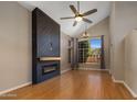 Bright living room featuring high ceilings, modern fireplace, and a large window at 4753 E Bighorn Ave, Phoenix, AZ 85044