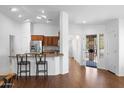 Open-concept living area with hardwood floors, bar seating and a bright, airy atmosphere at 4976 S Sugarberry Ln, Gilbert, AZ 85298