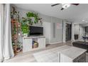 Comfortable living room featuring stylish decor, wood-look flooring, and plenty of plants at 5253 E Hilton Ave, Mesa, AZ 85206