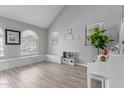 Bright living room with vaulted ceilings, wood-look flooring, and lots of natural light at 5253 E Hilton Ave, Mesa, AZ 85206
