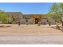 Charming desert home featuring a stone entryway and a beautifully landscaped front yard with native plants at 5515 E Dale Ln, Cave Creek, AZ 85331