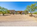 Beautiful desert home with xeriscaping, native trees, and a stone-accented facade creating an inviting curb appeal at 5515 E Dale Ln, Cave Creek, AZ 85331