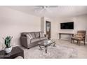 Cozy living room featuring neutral tones, comfortable seating, and a modern ceiling fan at 5633 E Colby St, Mesa, AZ 85205