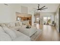 Bright living room with hardwood floors, large sectional, and backyard access at 5810 E Nora St, Mesa, AZ 85215