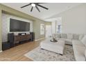Inviting living room with ceiling fan, textured wall accents, and a comfortable sectional sofa at 5810 E Nora St, Mesa, AZ 85215