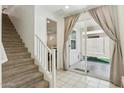 Hallway with tile floor, carpeted stairs, and sliding glass doors that lead to the backyard at 732 W Flintlock Way, Chandler, AZ 85286