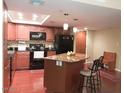 Bright kitchen featuring granite countertops, stainless appliances, and functional island with seating at 7970 E Camelback Rd # 209, Scottsdale, AZ 85251