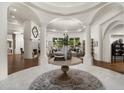 Grand foyer featuring decorative columns, a round wood table, and views of the formal living room at 8229 N Ridgeview Dr, Paradise Valley, AZ 85253