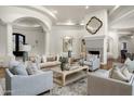 Cozy living room boasts a beautiful fireplace, neutral-toned furniture, and elegant decor at 8229 N Ridgeview Dr, Paradise Valley, AZ 85253