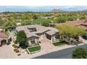Breathtaking aerial view of home on a golf course lot with lush desert landscaping and a refreshing pool at 8240 E Wingspan Way, Scottsdale, AZ 85255