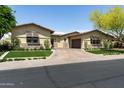 Beautiful home with manicured turf, stone accents, and a well-maintained circular driveway at 8240 E Wingspan Way, Scottsdale, AZ 85255
