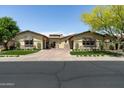 Charming front exterior featuring low-maintenance landscaping and a private courtyard at 8240 E Wingspan Way, Scottsdale, AZ 85255