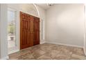 Inviting foyer with double doors, tile flooring, and natural light from side windows at 8627 W Morrow Dr, Peoria, AZ 85382
