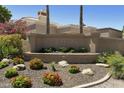 Community sign with a rock and floral landscape features the name SUNTRREE EAST at 9484 N 105Th Pl, Scottsdale, AZ 85258