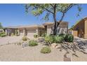 Attractive home showcasing desert landscaping and a mature tree for shade at 9562 E Cavalry Dr, Scottsdale, AZ 85262