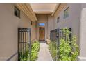 Inviting front entrance with gated courtyard and lush greenery at 9562 E Cavalry Dr, Scottsdale, AZ 85262